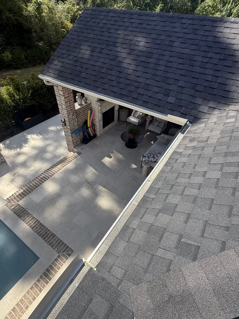 Gutter guard installed along the roofline above an outdoor patio and pool area